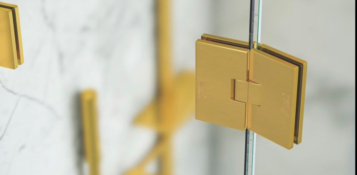 Brushed brass-gold glass hinge detail